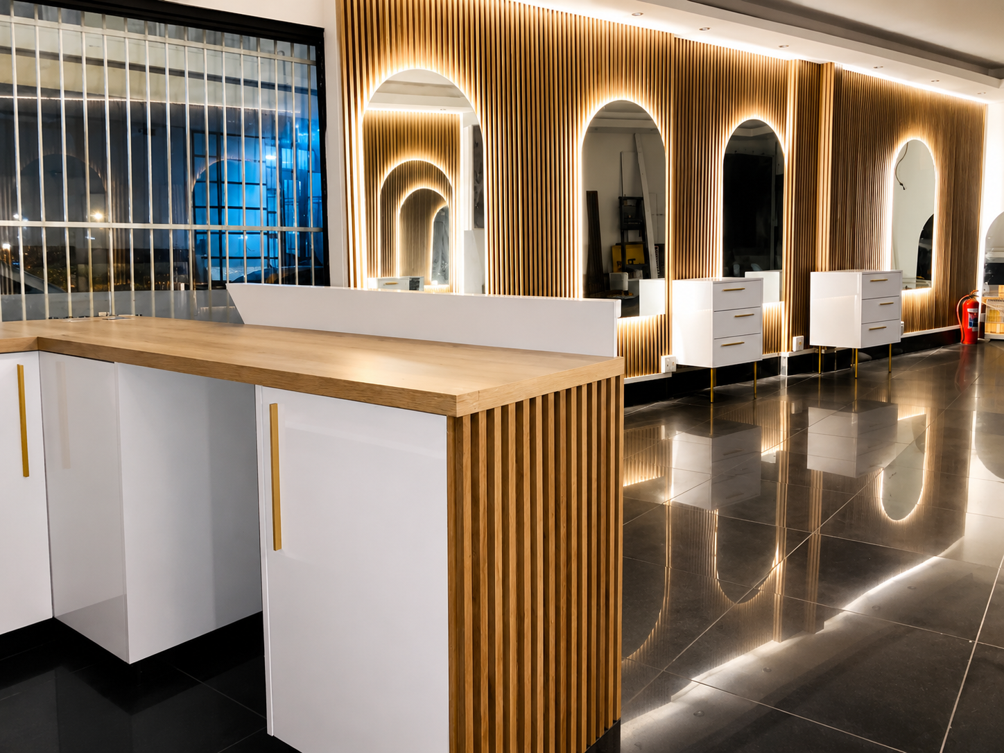 The full arched-mirror gallery and reception counter — the finished studio ready for the day
